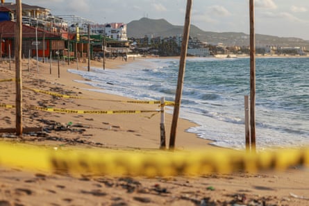 Yellow tapes on Medano Beach on Sunday as Hurricane Polo approaches Baja California Sur, in Cabo San Lucas, Mexico.