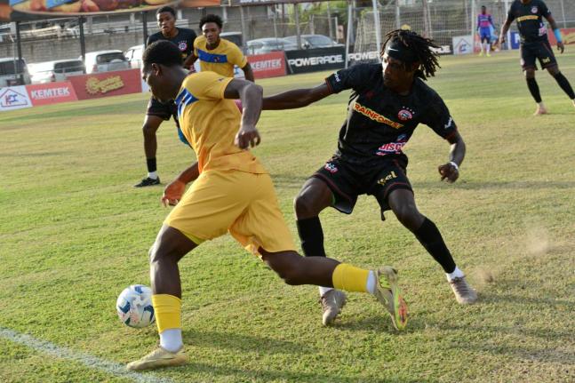 Deonjay Brown (right) of Montego Bay United and Adriel George of Racing United battle for the ball during their Jamaica Premier League match at the Waterhouse Stadium on Sunday. Waterhouse won 2-0