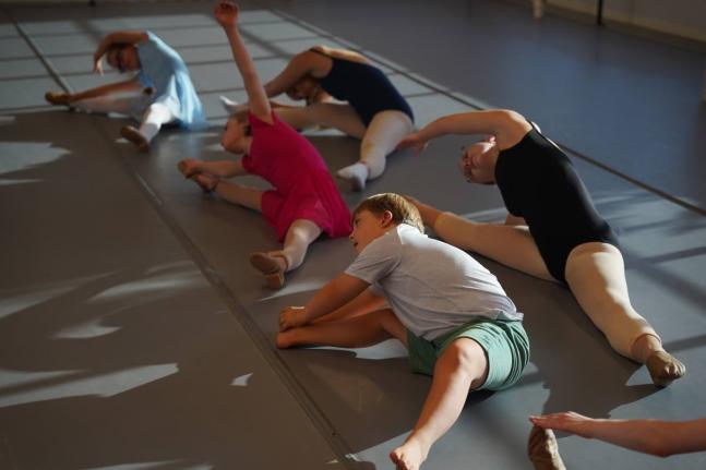 Students stretch during a Dance Abilities class at the Academy of Dance Arts in the Indianapolis suburb of Fishers.