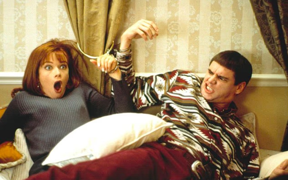 Lauren Holly e Jim Carrey em Debi & Lóide: Dois Idiotas em Apuros (1994) — Foto: Reprodução